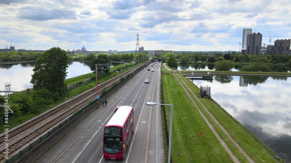 Traffic on road leading along with railway tracks between water reservoirs Traffic on road leading along with railway tracks between water reservoirs