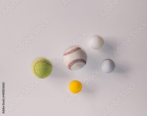 different balls for different sports such as baseball, tennis, ping pong, frontenis and golf on white background with copy space. photo