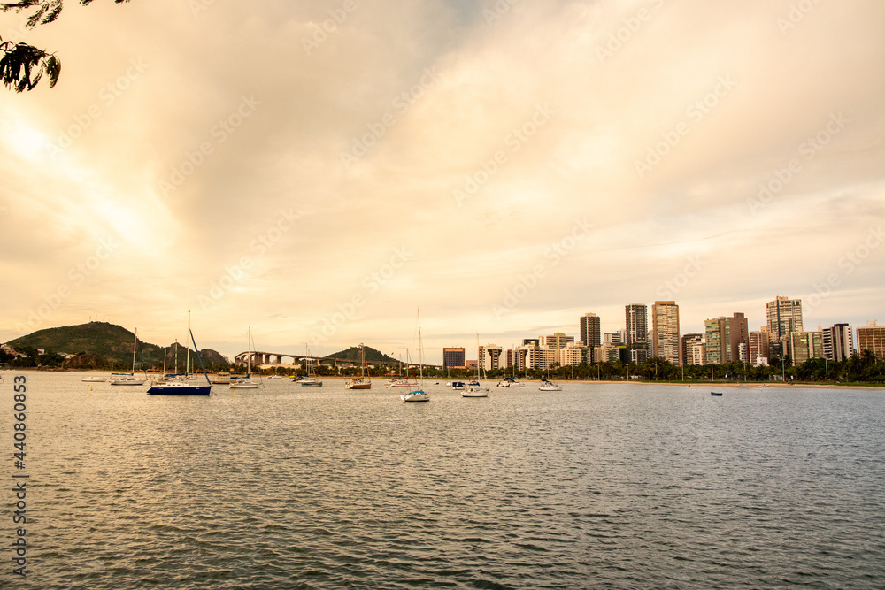Fototapeta premium Panoramic photo of the city of Vitoria, capital of Espirito Santo State, Brazil. Boats and buildings. Third bridge and the penha convent in the background. Tourist spots