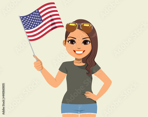 Young beautiful latina woman smiling waving USA flag