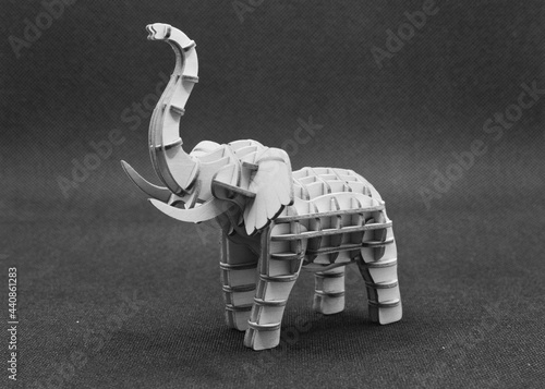 elephant wooden toy on black and white