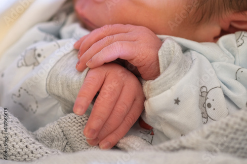Little adorable newborn child boy hands close-up while sleeping,innocence family love concept