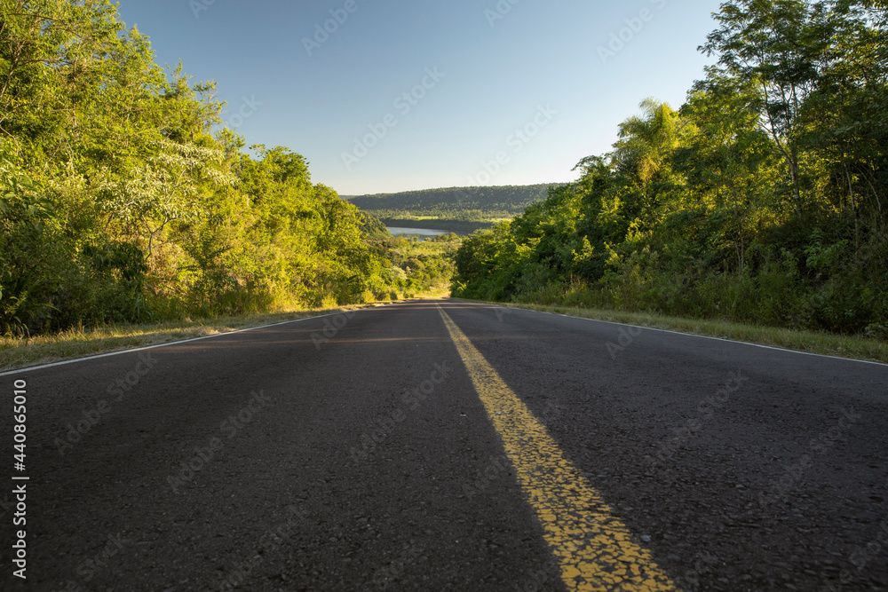 Road trip. View of the empty asphalt highway across the tropical rainforest. Road trip. View of the empty asphalt highway across the tropical rainforest.