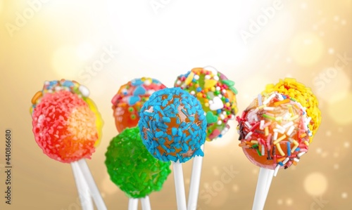 Brightly colored cake pops on a colored background