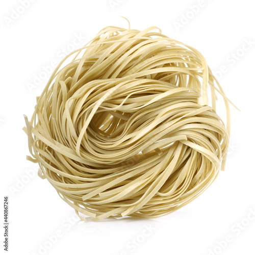 Italian pasta tagliatelle nest on white background