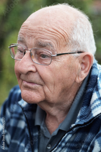 Elderly man with glasses and gray hair portrait