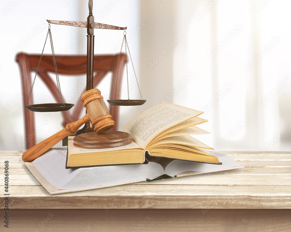 Justice and law concept. Gavel and books on table in morning light Justice and law concept. Gavel and books on table in morning light