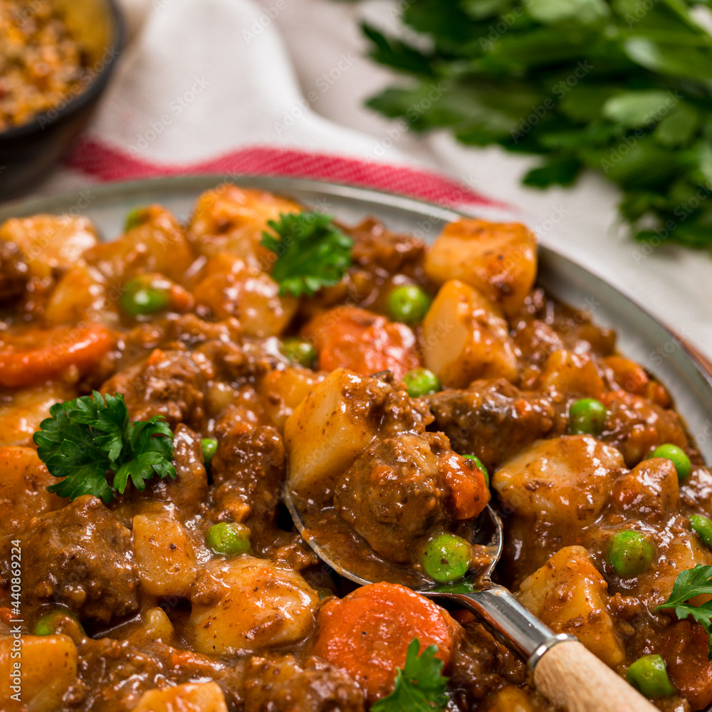 Beef Curry Stew with Potatoes and Carrots on Wooden Background. Selective focus. Beef Curry Stew with Potatoes and Carrots on Wooden Background. Selective focus.