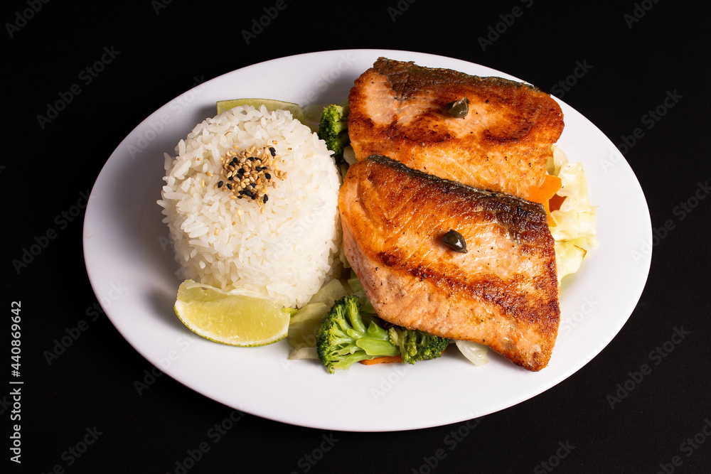 dish with grilled salmon rice and vegetables