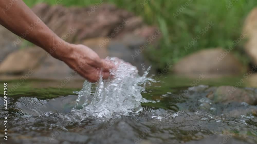 close up hand touching water in the forest river nature and life concept close up hand touching water in the forest river nature and life concept