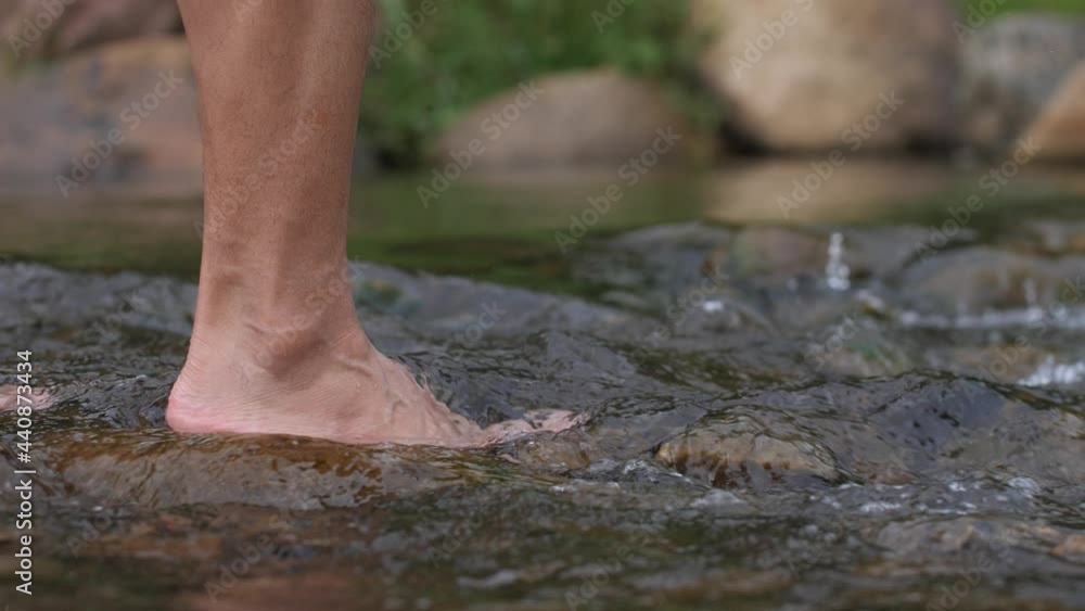 close up hand touching water in the forest river nature and life concept close up hand touching water in the forest river nature and life concept