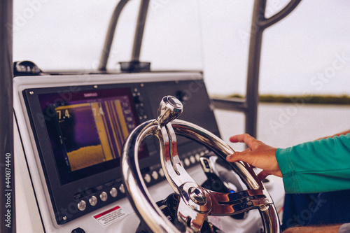 Photography Fishing captains hands on the steering wheel of a boat