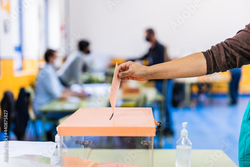 Autonomous community of Madrid elections. Democraty referendum for government vote. Hand posing an envelop in a ballot box for community elections photo