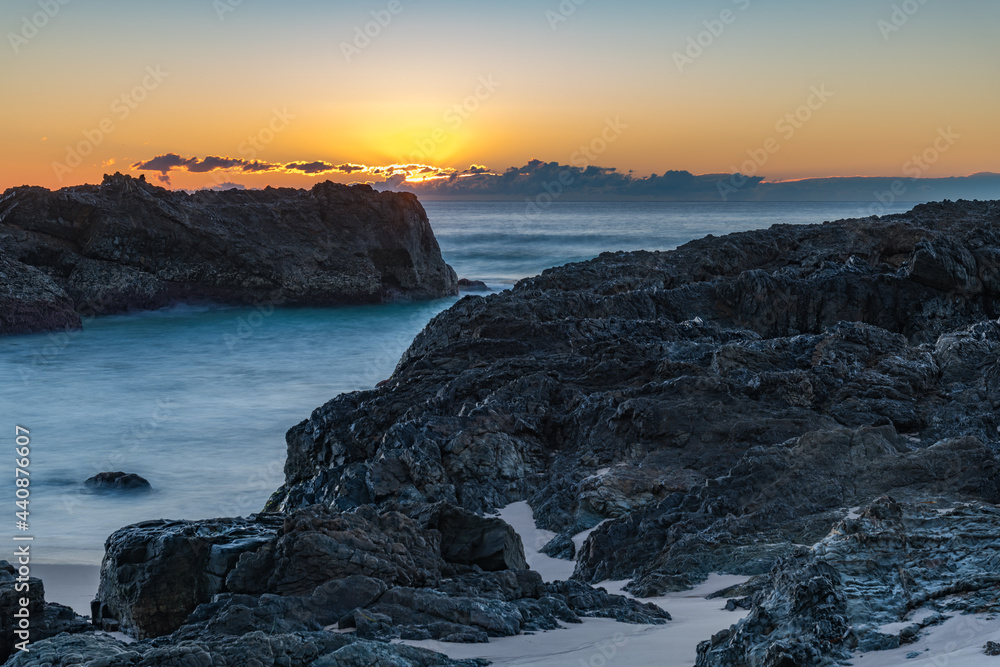 Sunrise seascape and a rocky beach