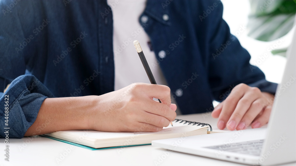 Study online class, Woman hand writing on notebook while learning online course, Education and technology, Work from home Study online class, Woman hand writing on notebook while learning online course, Education and technology, Work from home