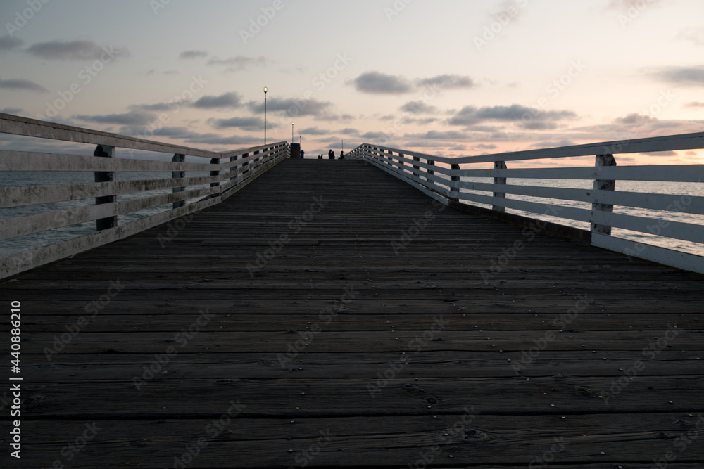Fototapeta premium Sunset highlights on white rail of Crystal Pier, San Diego