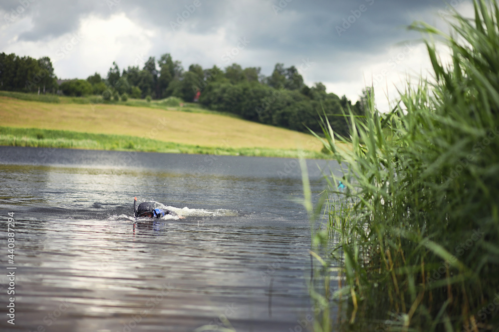 A scuba diver in a wet suit prepares