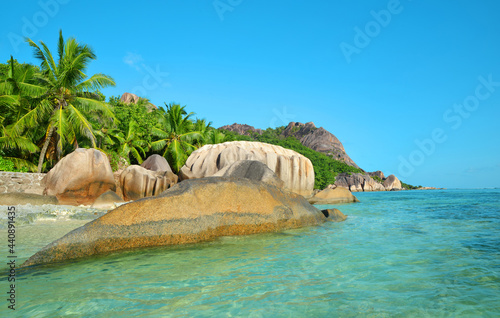 Beatiful beach Anse Source d'Argent with big granite rocks in sunny day. La Digue Island, Seychelles.