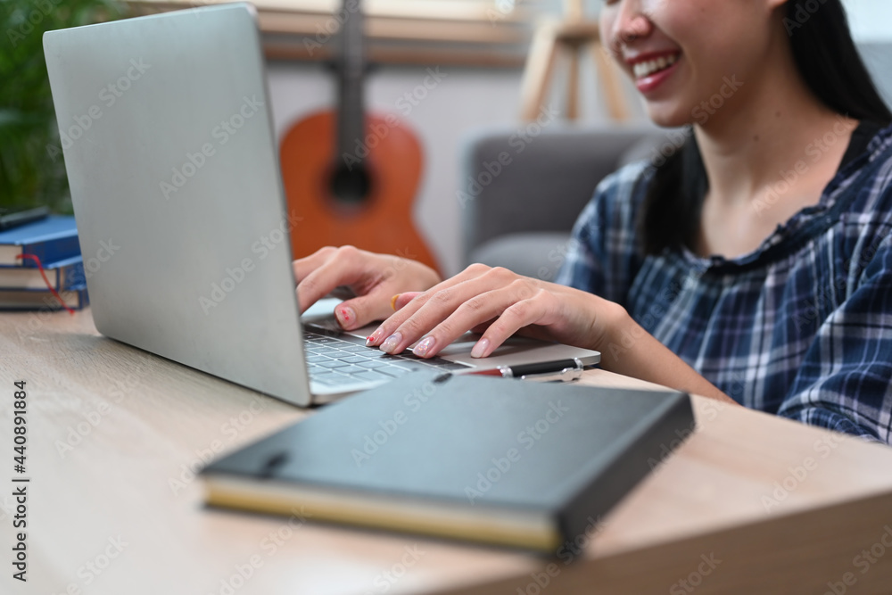 Smiling young woman surfing internet with laptop at home. Smiling young woman surfing internet with laptop at home.