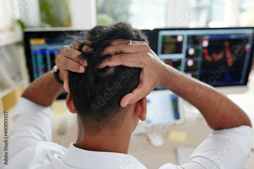 Stock trader tearing out his hair in frustration after loosing money of his clients