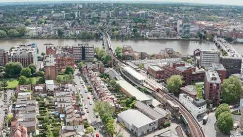 Stationary aerial drone shot of Putney bridge Tube station West London photo