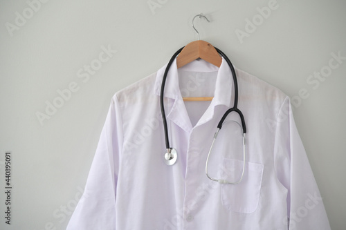Doctor coat hanged on clinic office wall