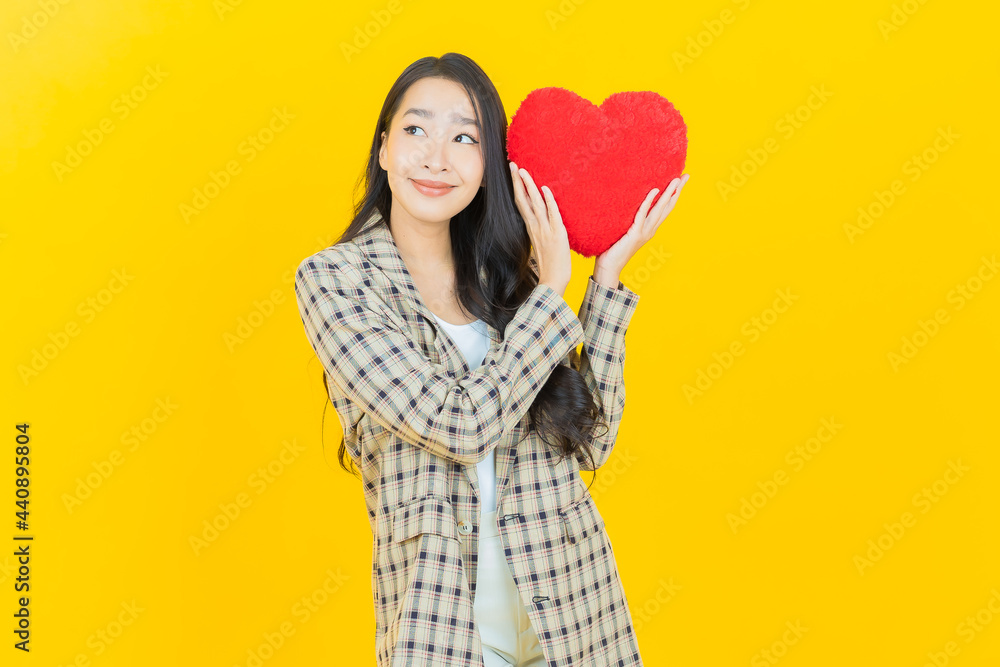Portrait beautiful young asian woman smile with heart pillow shape Portrait beautiful young asian woman smile with heart pillow shape