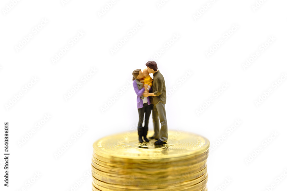 Money, Financial, Business, Cryptocurrency, Security and Family concept. Parent and child miniature figures hug and kiss together standing on stack of gold Bitcoin coins isolated on white background. Money, Financial, Business, Cryptocurrency, Security and Family concept. Parent and child miniature figures hug and kiss together standing on stack of gold Bitcoin coins isolated on white background.