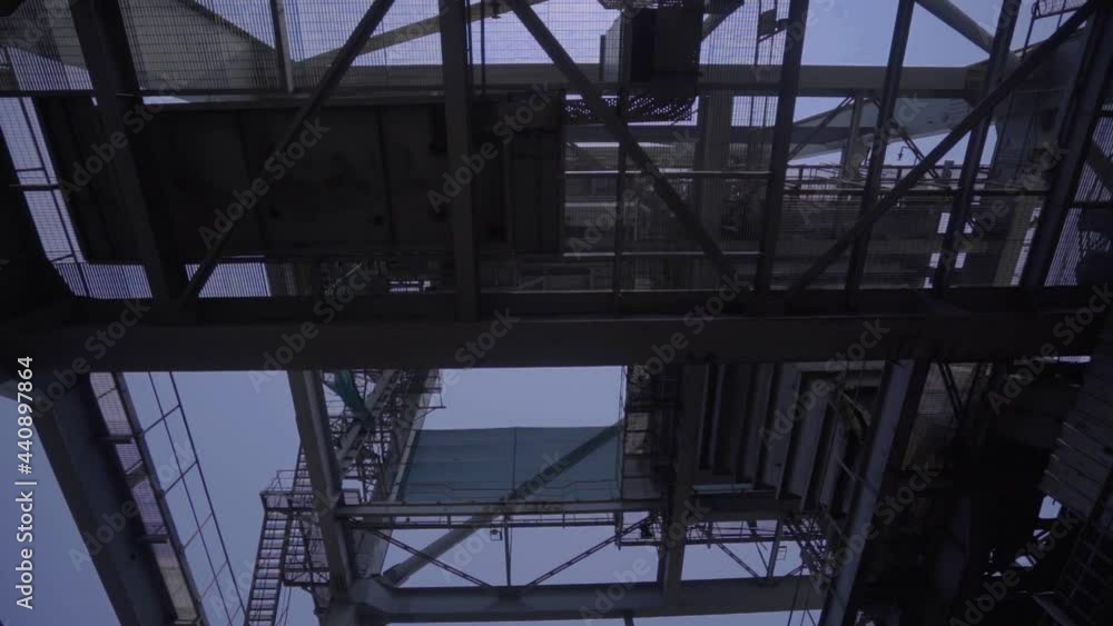 View Under Huge Steel Crane Mast At The Port Of Paradip In India. low angle, POV View Under Huge Steel Crane Mast At The Port Of Paradip In India. low angle, POV