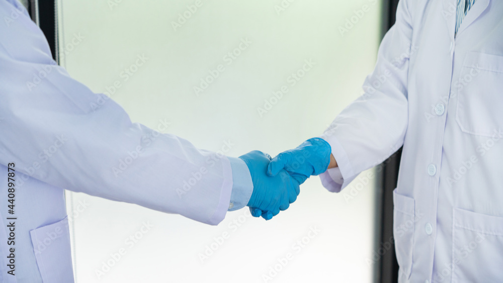 A scientist wearing medical isolation gown investigating the growth, structure development, and other characteristics of microscopic organisms A scientist wearing medical isolation gown investigating the growth, structure development, and other characteristics of microscopic organisms