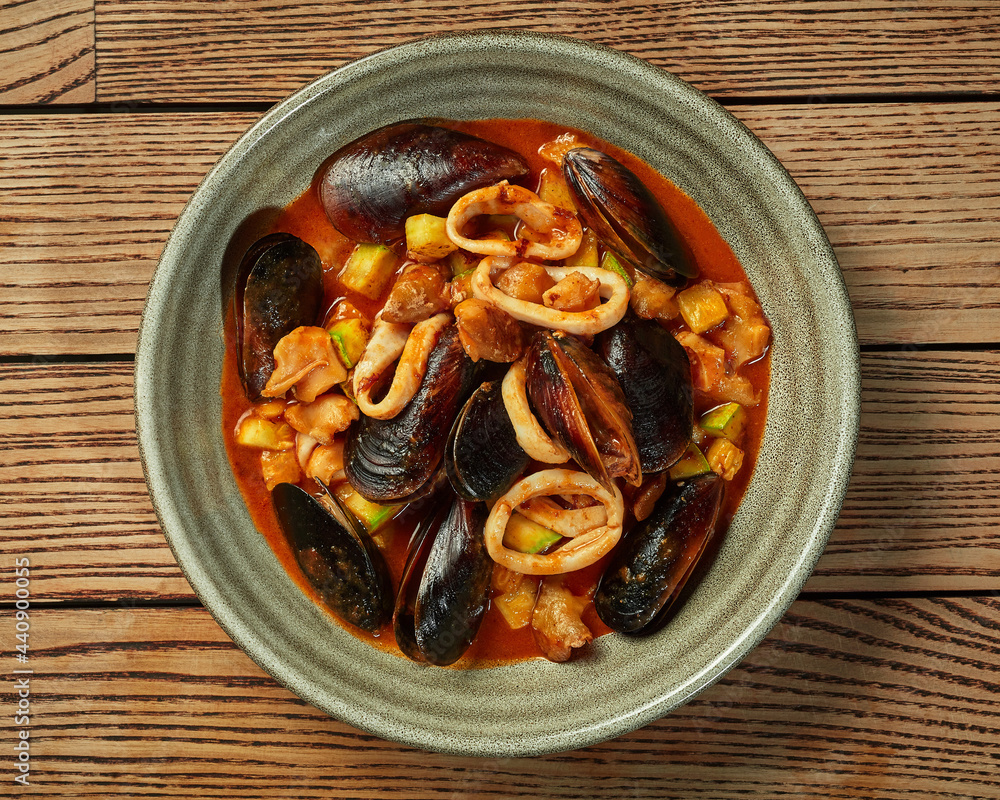 Seafood stew with fish, mussels, squid, whelks and vegetables