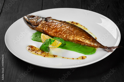 Grilled mackerel with green pea puree, herbal sauce and lemon