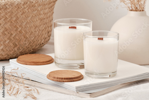 Handmade scented candles in a glass with a wooden lid. Soy wax candles with a wooden wick. Front view.