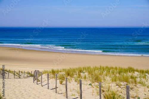 Obraz na plátně beach sea access in sandy dunes and fence of atlantic ocean waves at le porge co
