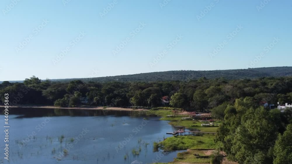 hovering over the coastline of a beautiful lake hovering over the coastline of a beautiful lake
