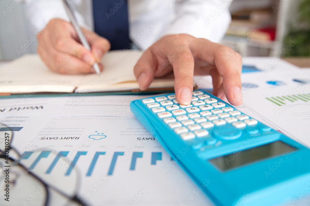 Accountant using calculator hand close-up Accountant using calculator hand close-up