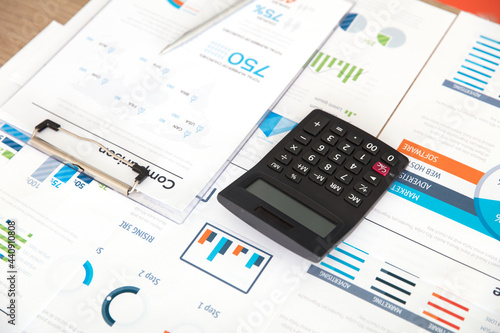 Calculator and pen on financial documents © zhenya