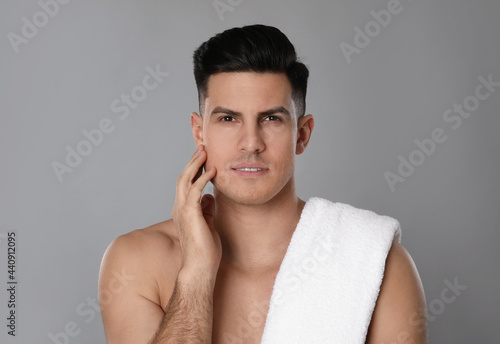 Handsome man after shaving on grey background