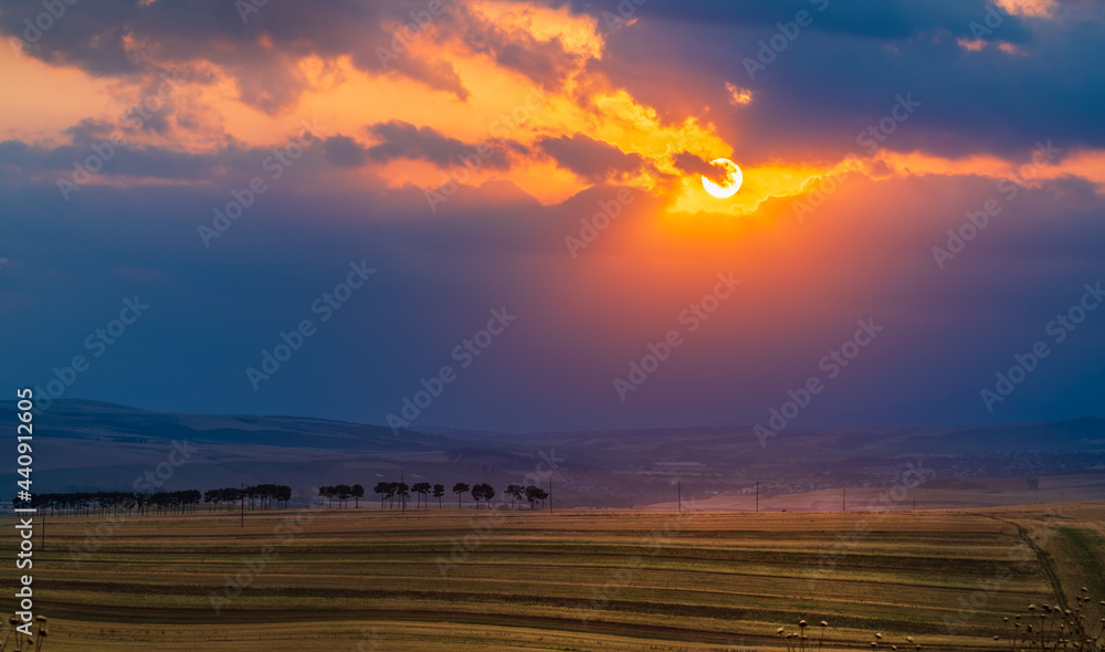 Dramatic sunset over farm fields