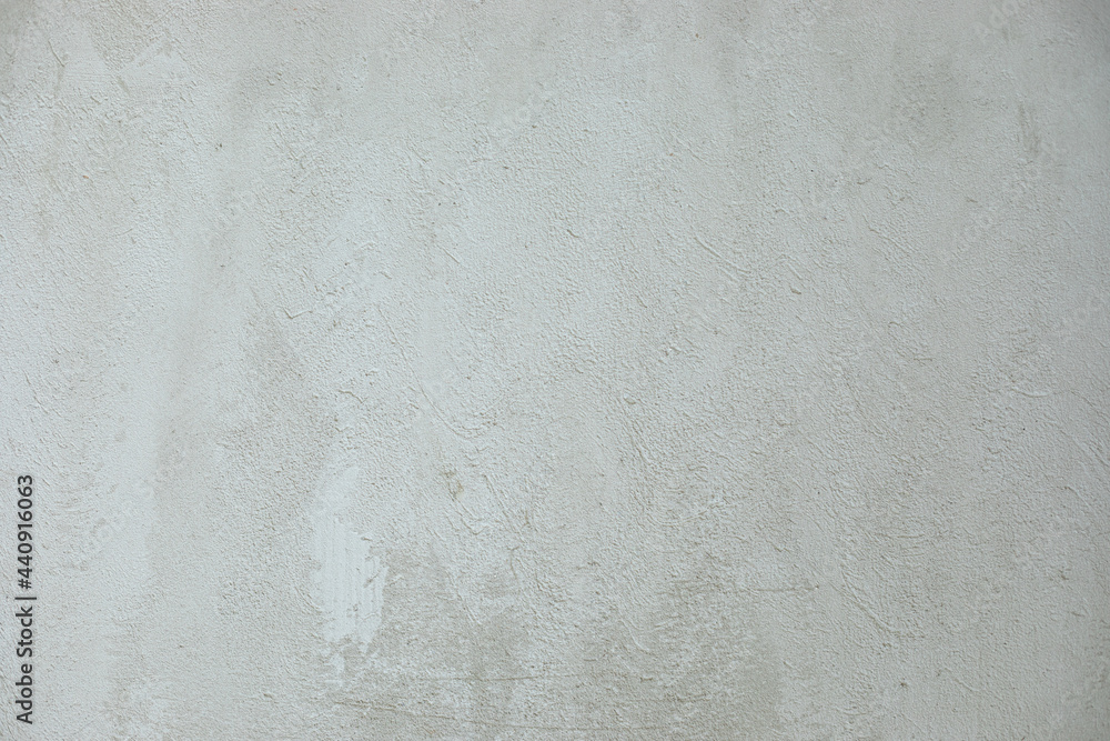 Photo of bright light white gray grunge stone concrete or cement plaster facade wall texture background Photo of bright light white gray grunge stone concrete or cement plaster facade wall texture background
