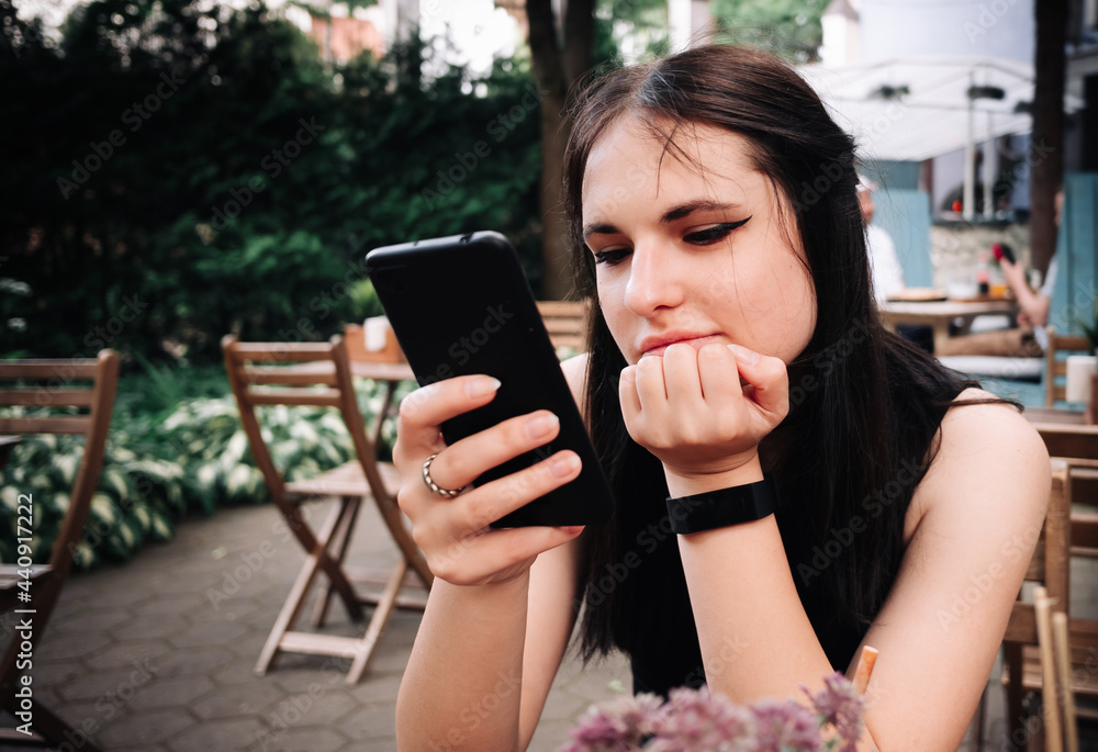 young woman or teenage girl using mobile phone in cafe outdoor young woman or teenage girl using mobile phone in cafe outdoor