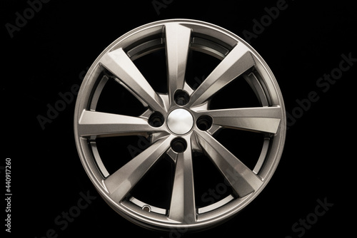 grey alloy wheel, modern auto parts. black background front view © Vladimir Razgulyaev