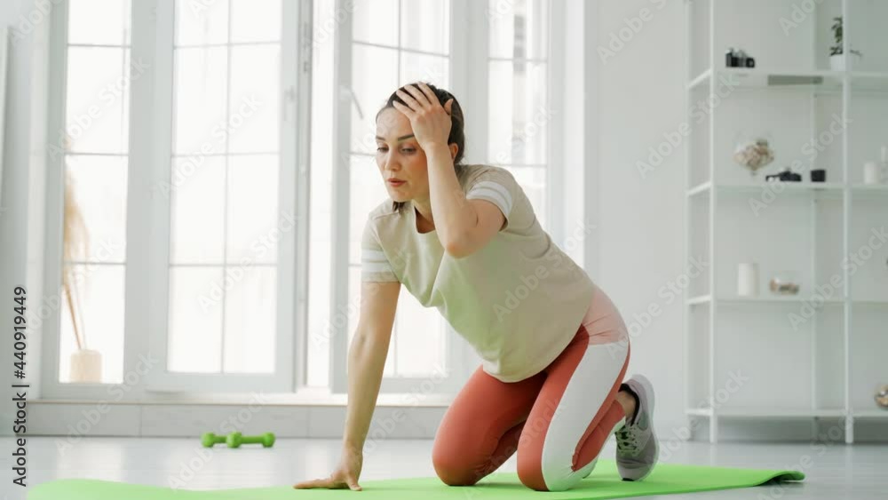 The girl conducts distance fitness training online. The girl shoots her fitness video blog on a smartphone. The girl conducts distance fitness training online. The girl shoots her fitness video blog on a smartphone.