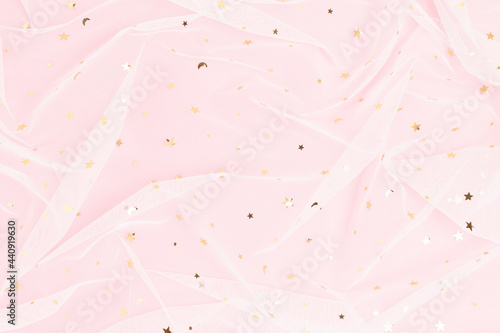 Minimal pink pastel colored background with shiny golden glitter.