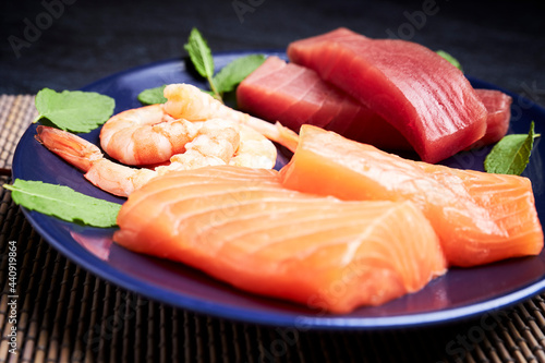 Plate with salmon  tuna and shrimp to make sushi. Delicious Japanese food