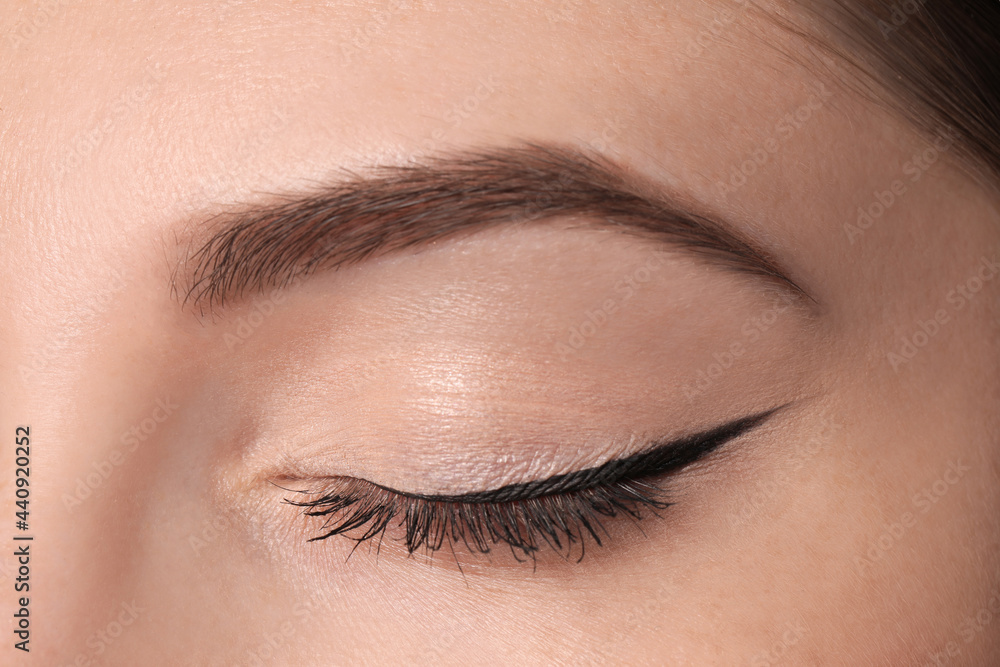Obraz premium Beautiful woman with black eyeliner, closeup view