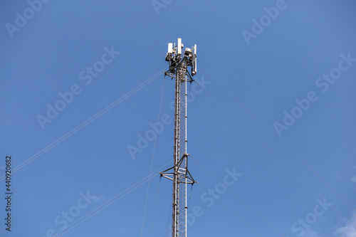 transmitter atop a cell phone pole About to be upgraded from 4g to 5g. High-risk electrical engineer job in Thailand.
