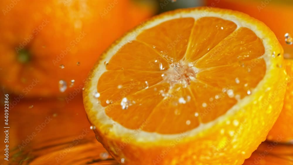 Super Slow Motion Shot of Water Splashing on Fresh Orange at 1000fps. Super Slow Motion Shot of Water Splashing on Fresh Orange at 1000fps.