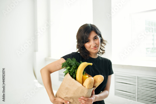 woman in black t-shirt package with groceries shopping homework