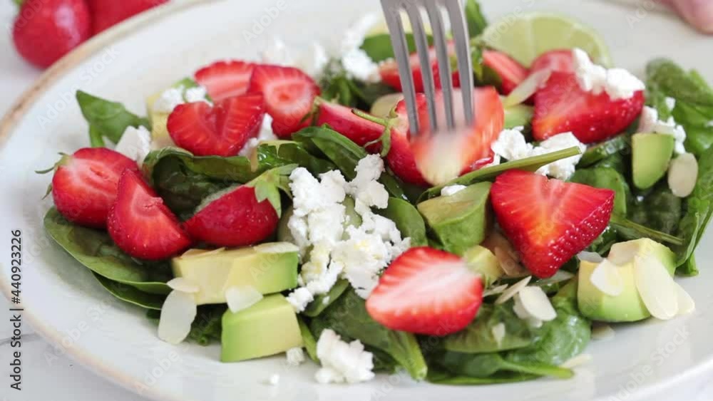 Strawberry salad with spinach, feta cheese, avocado and almonds. Strawberry salad with spinach, feta cheese, avocado and almonds.